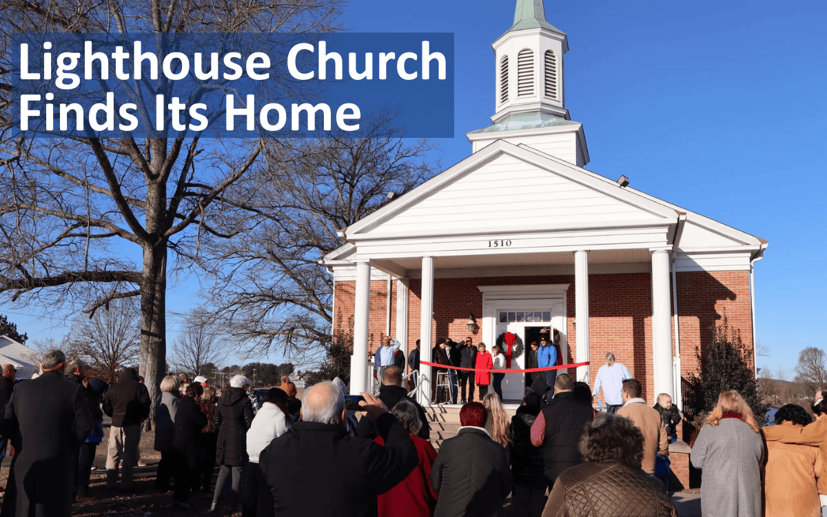 Lighthouse Church Members gather for the ribbon cutting ceremony of its new location.